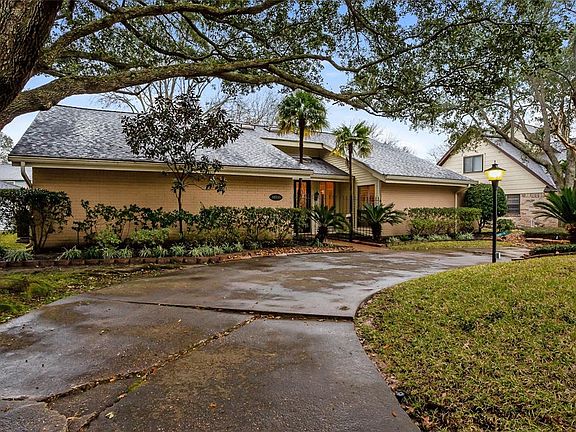 Another Front View Showing the Trimmed Mature Trees, Lovely Landscaping, Roof done in 2009, Gated Entry to Home.