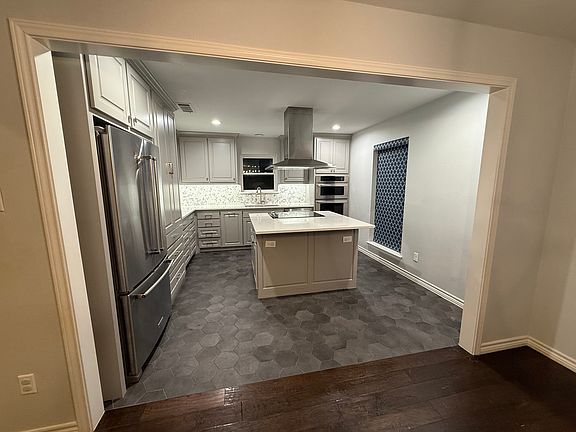 The newly renovated kitchen includes a bar overhang, perfect for breakfast and chatting while cooking!