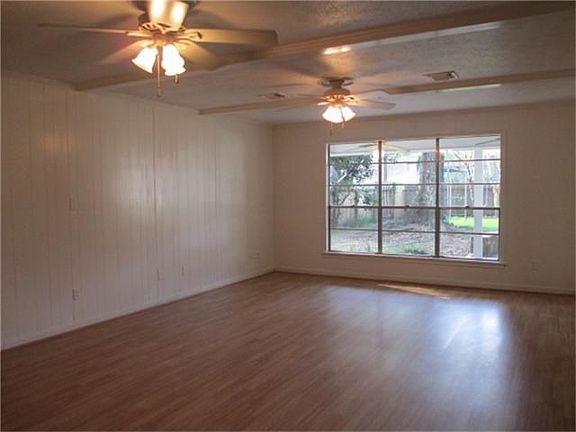 The living room is huge and has 2 ceiling fans.