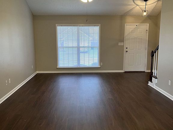 great room with vaulted ceiling and new ceiling fan