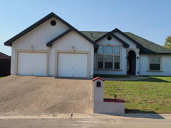 Large 2 door garage with long driveway. Mail box with planter.