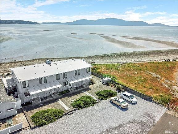 Aerial view of condo building/parking area. Note: roof, siding, decks, fences and exterior paint have been redone since this photo was taken.