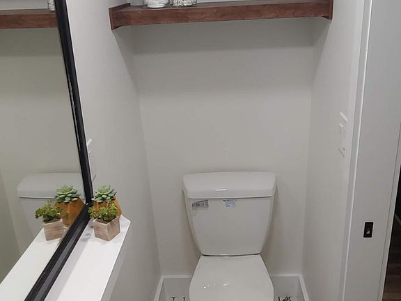 Extra strong and durable shelving above toilet for extra storage.
