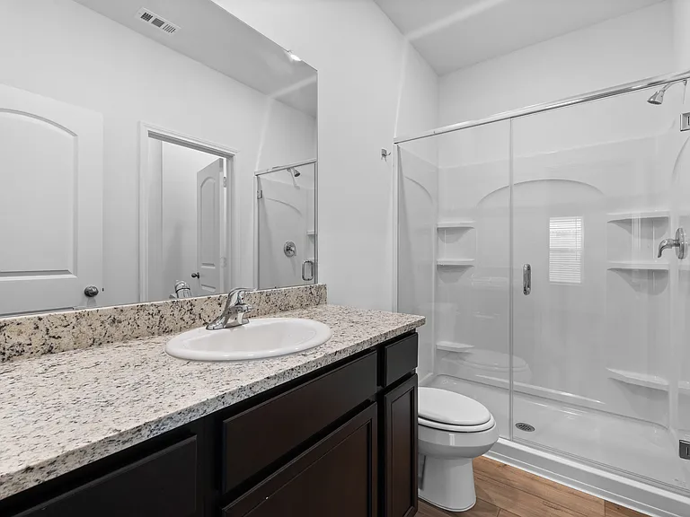 The master bathroom has a large step-in shower.