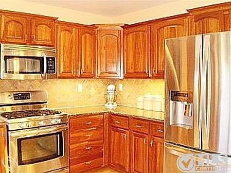 2 kitchen with cherry cabinnets.