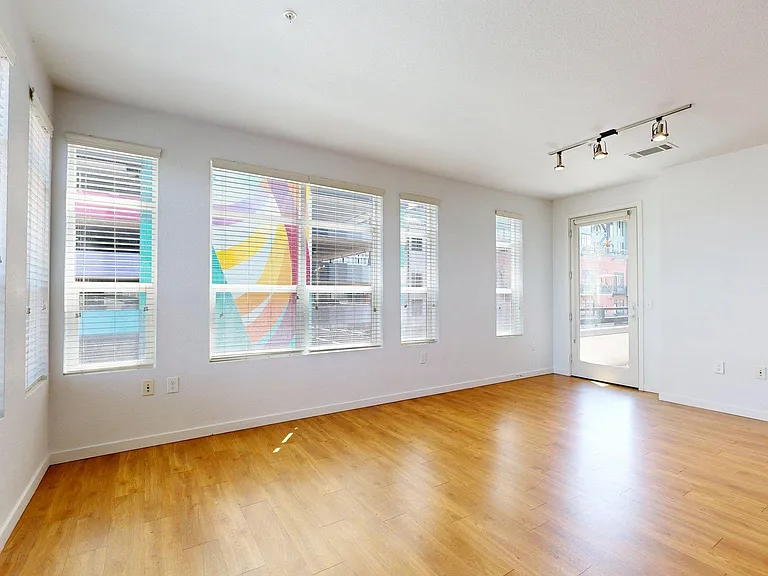 Apartment living room with wood-style flooring.