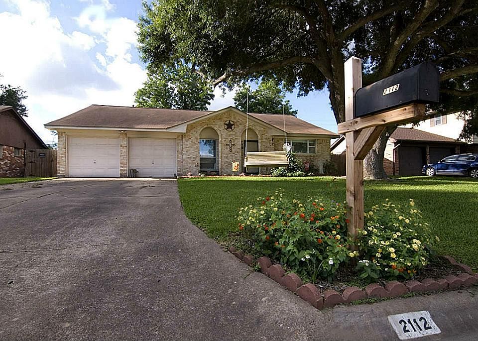 The large and spacious driveway leads to a 2 car garage with work station.