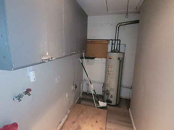 Utility room, with waher/dryer hook ups and access to attic.