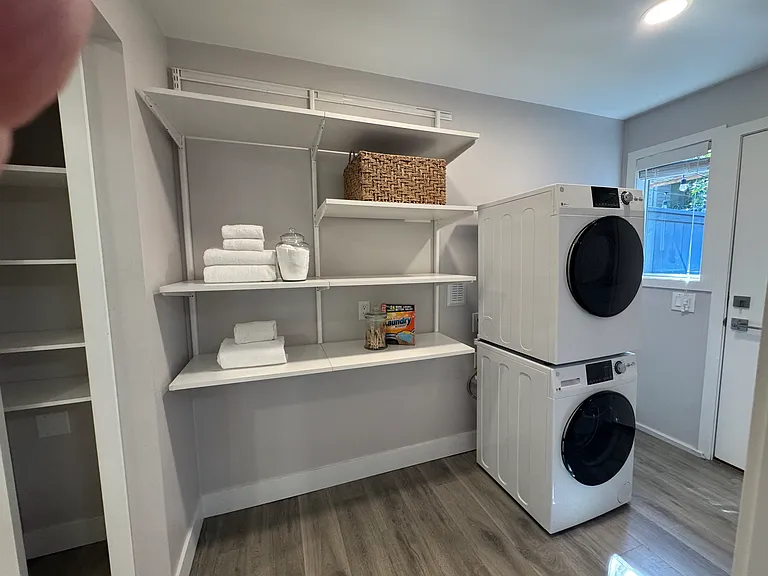 Laundry area with stacked washer/dryer and custom shelving. Direct outdoor access to your very large patio.
