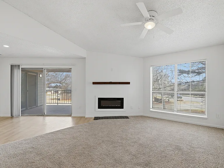 B2 - Two Bedroom Two Bathroom living room with electric fireplace and large patio access.