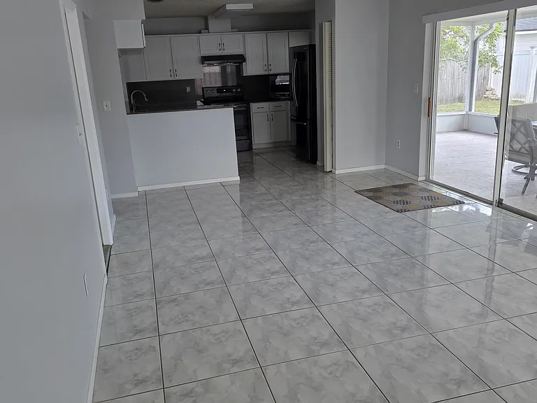 dining room corner area showing dining room and kitcen as well as sliding door leading to outside patio