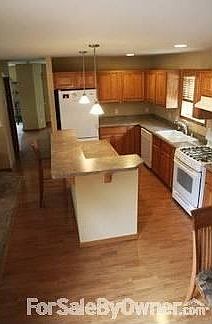 Kitchen
						:
						Spacious Countertops with island. Also serves as a breakfast nook.