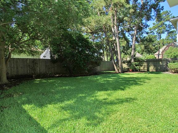 The Back Yard features a mature landscape that provides a tranquil and private backdrop to the lush lawn.