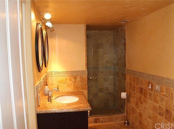 Travertine and granite throughout this stunning bathroom