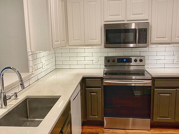 Quartz countertops and hand-glazed Italian subway tile backsplash