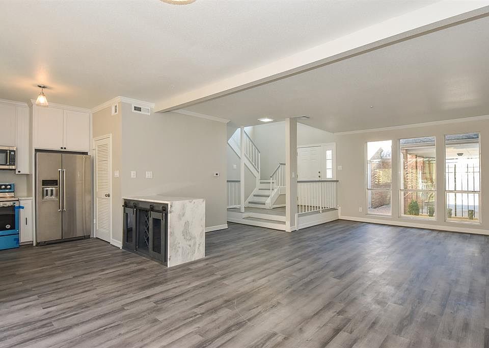 Very open floor plan with double paned windows in living area, recent flooring throughout and recent stainless Kitchen Aid appliances included. The custom Quartite island offers wine rack and storage with sliding barn doors.