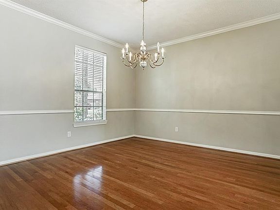 Formal Dining Room With Wood Floors*Chair Railing*Crown Molding*Freshly Painted.