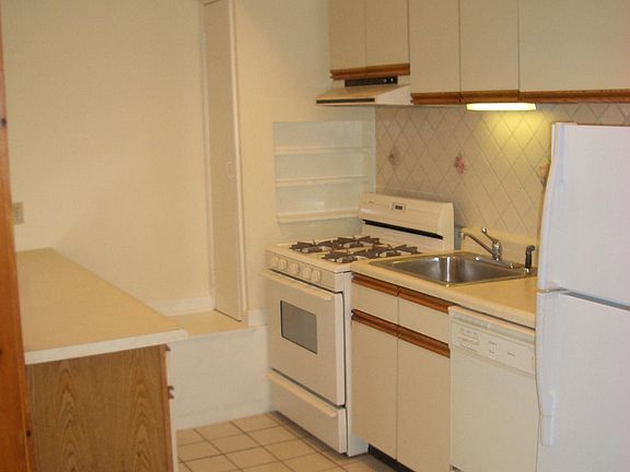 Kitchen with ceramic tile backsplash and tile floor