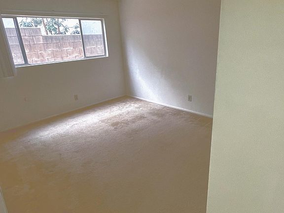 Bedroom with natural light, block wall creates privacy