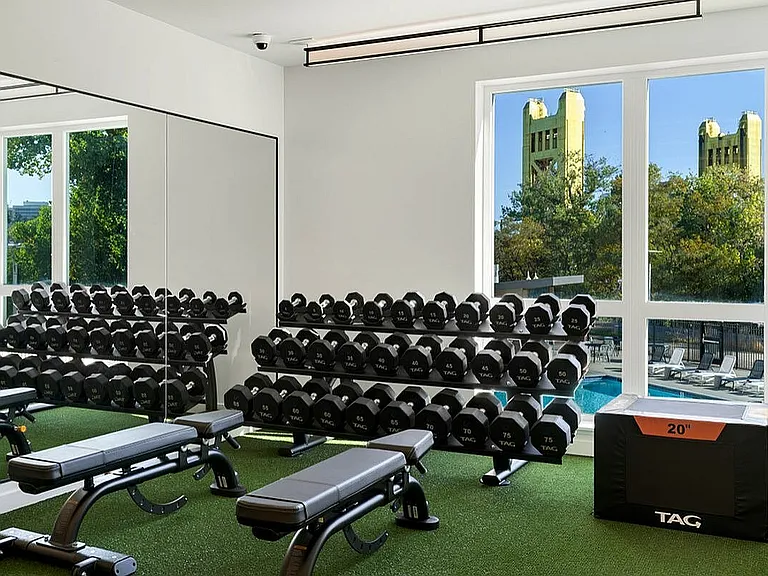 Elevate your workout in our well-equipped fitness center overlooking the pool at 805 Riverfront in Sacramento with City View