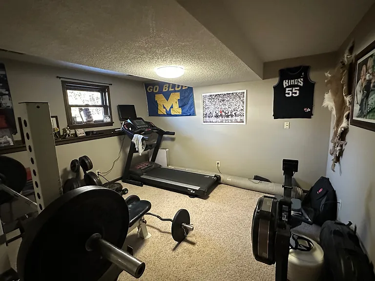 This is the 5th bedroom in the house and is located on the lower level with a full bath across the hallway. The current tenant uses this space for their weight room.