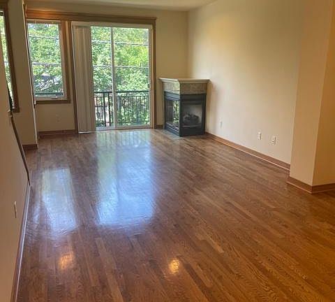 Main living area has hardwood floors and gas fireplace