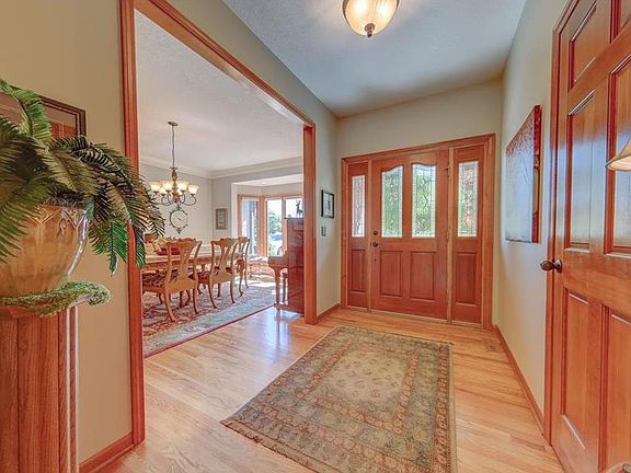 Beautiful wide open entry, hardwood floors and gorgeous wood all around you.