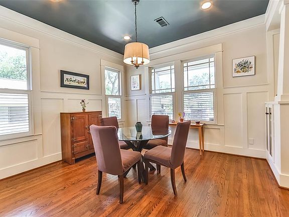 Dining room off of the living room has glass front built in cabinet to show china and glassware.  Designer paint finishes the elegant room.