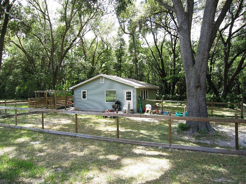 Cozy home tucked under granddaddy oaks w/fenced yard
