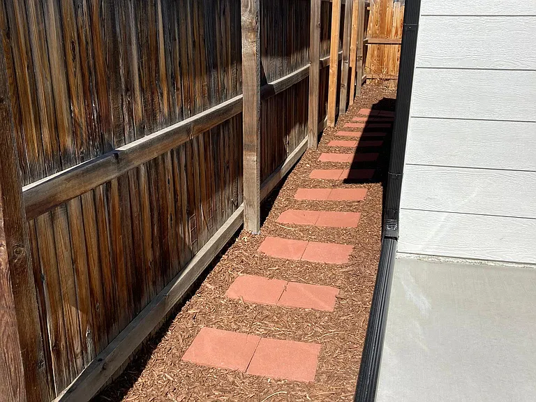 Side walkway from driveway to the back of the house.