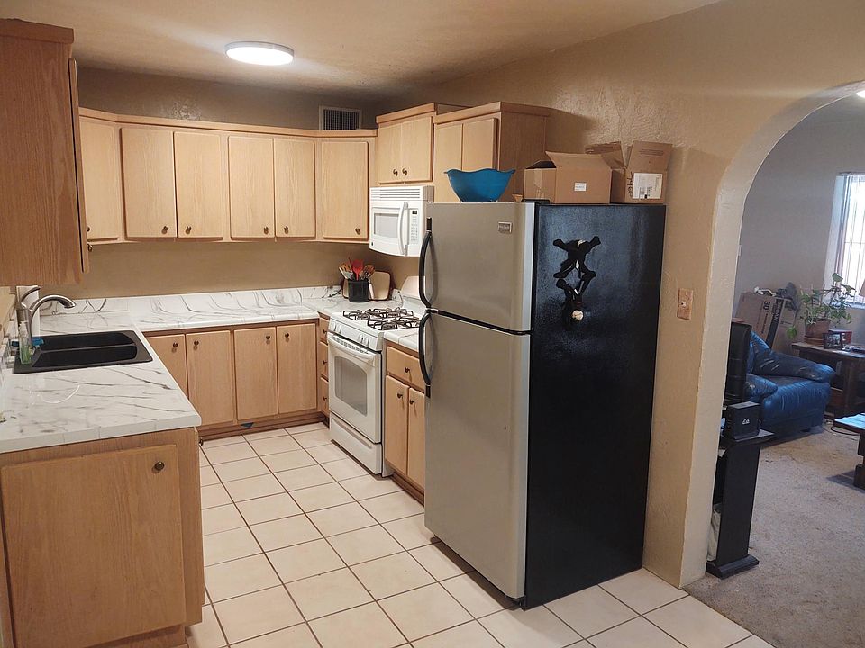 Kitchen, microwave, dishwasher, and large fridge