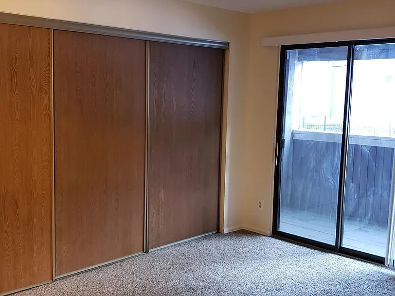 Bedroom with sliding door and closet