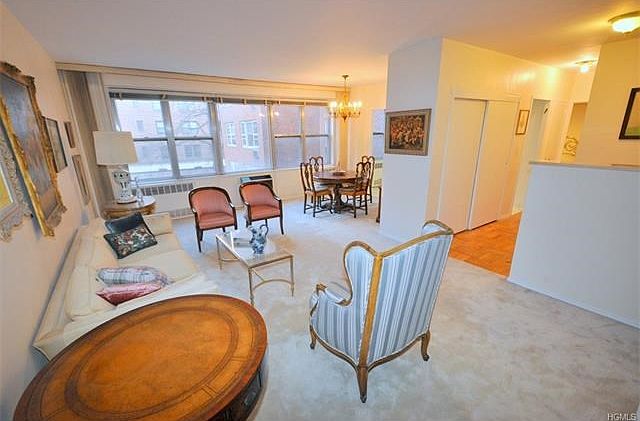 The large living room and "L" shaped dining room has covered parquet floors, wall of windows and overlooks the back courtyard.  The living room is 21'-0" x 12'-3" and the dining area is 10'-0" x 8'-3".