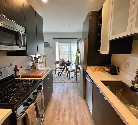 Galley kitchen with gas stove. All appliances are stainless.