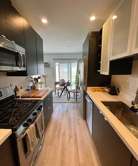 Galley kitchen with gas stove. All appliances are stainless.