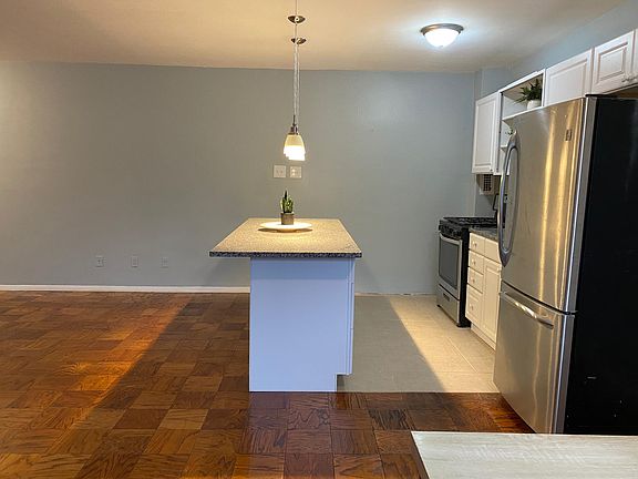 Kitchen with granite island and plenty of cabinets open living/dining/kitchen