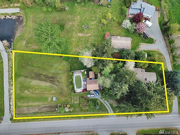 Aerial view of property shows home, 2 car detached garage, in-ground pool, pool house & outbuildings. Property lines are for ill