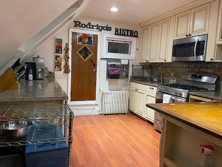 Modern spacious kitchen with stainless steel appliances.