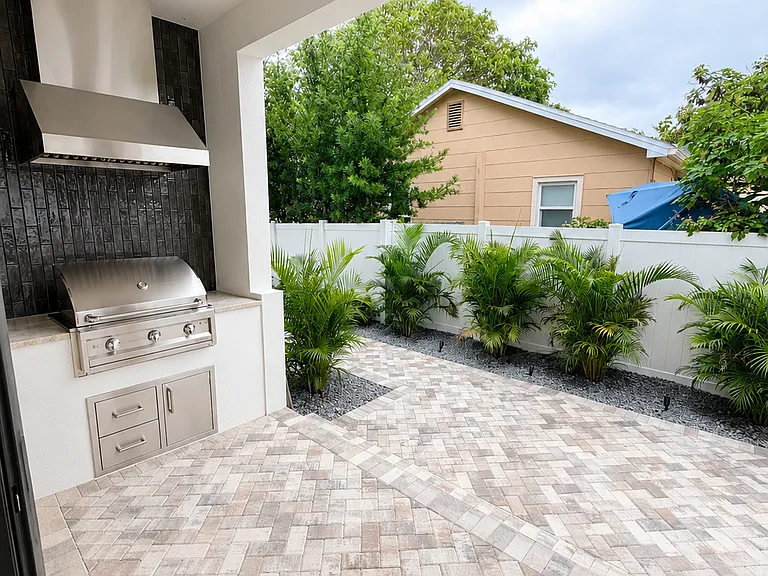 Backyard- Paved back porch and yard to be furnished with table and chairs for outdoor entertaining.