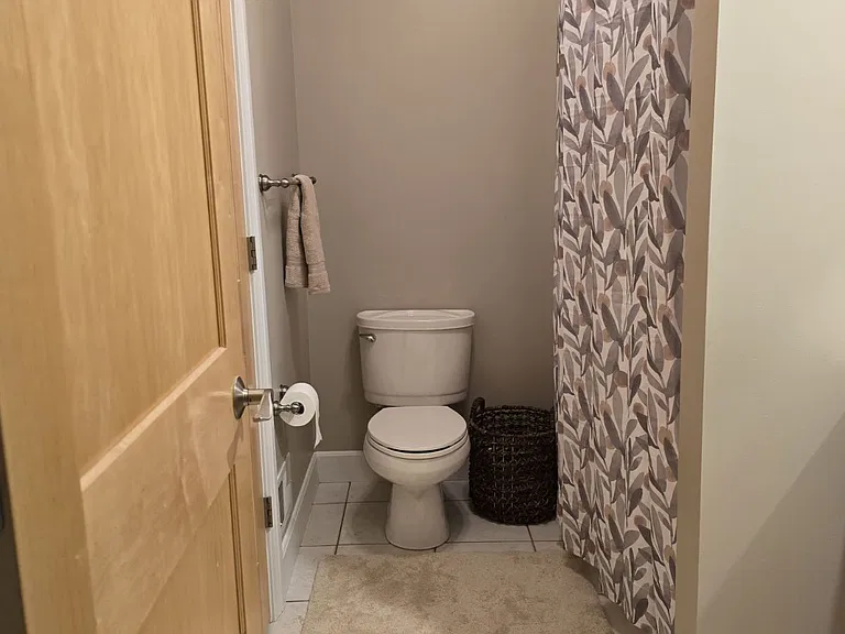 Newly decorated bathroom. Ceramic tile floor. Maple doors and cabinets.
