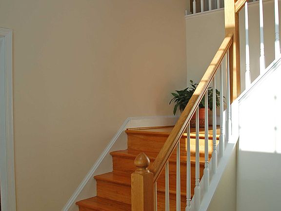 Foyer with turned,hardwood staircase