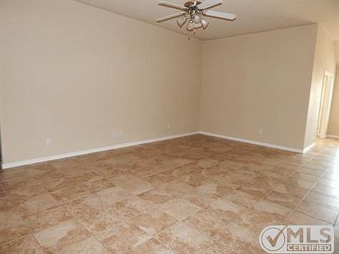 The living room offers tile floor and ceiling fan for added comf