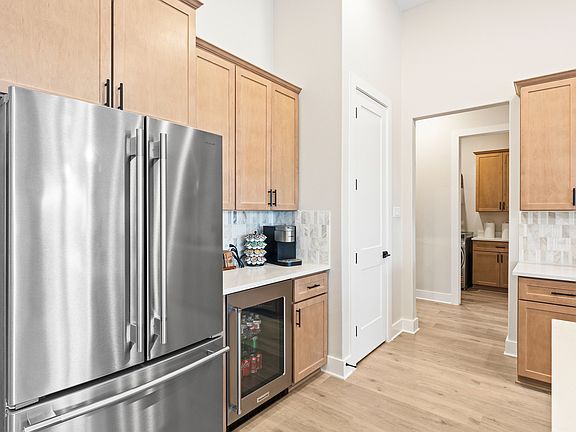 The kitchen has a double door refridgerator with a freezer drawer.
