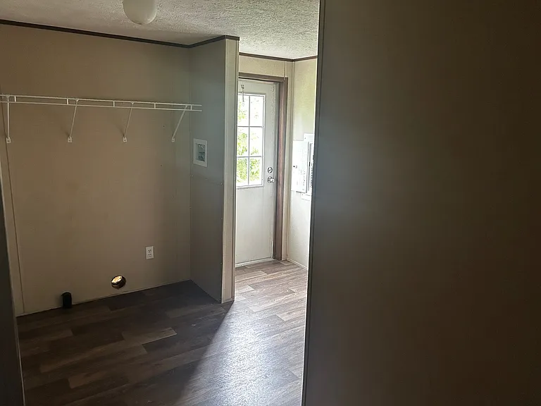 Utility Room with Washer and Dryer connections and rear exit door.
