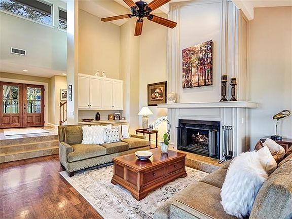 Volume everywhere in this fabulous living area. The dramatic entry boasts two story ceiling windows 