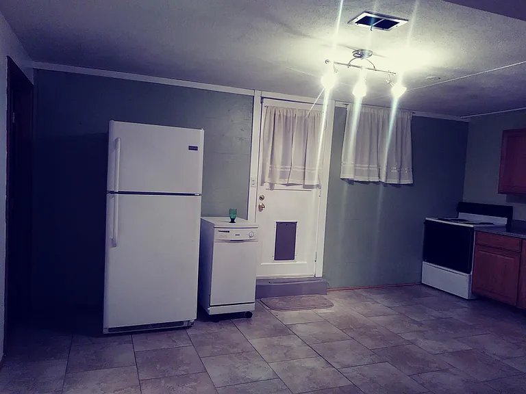 Fridge, dish washer, doggy door & stove. Large kitchen with tiled floor.