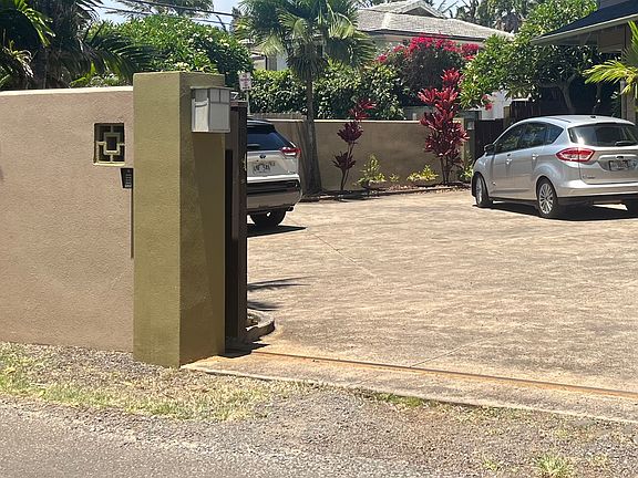 Entry gate opens to spacious parking