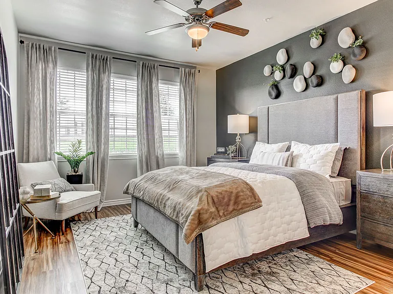Large bedroom with faux wood floors in Las Colinas.