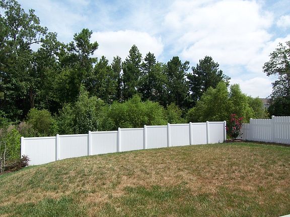 Private yard backs up to protected wooded area.