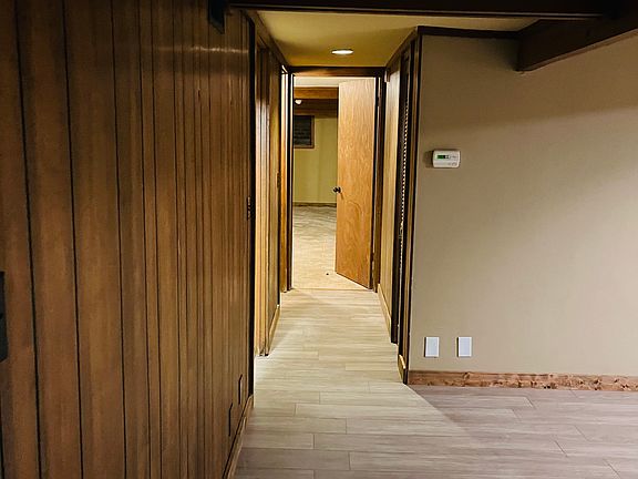 Standing in living area looking towards where both bedrooms and bathroom locations.
